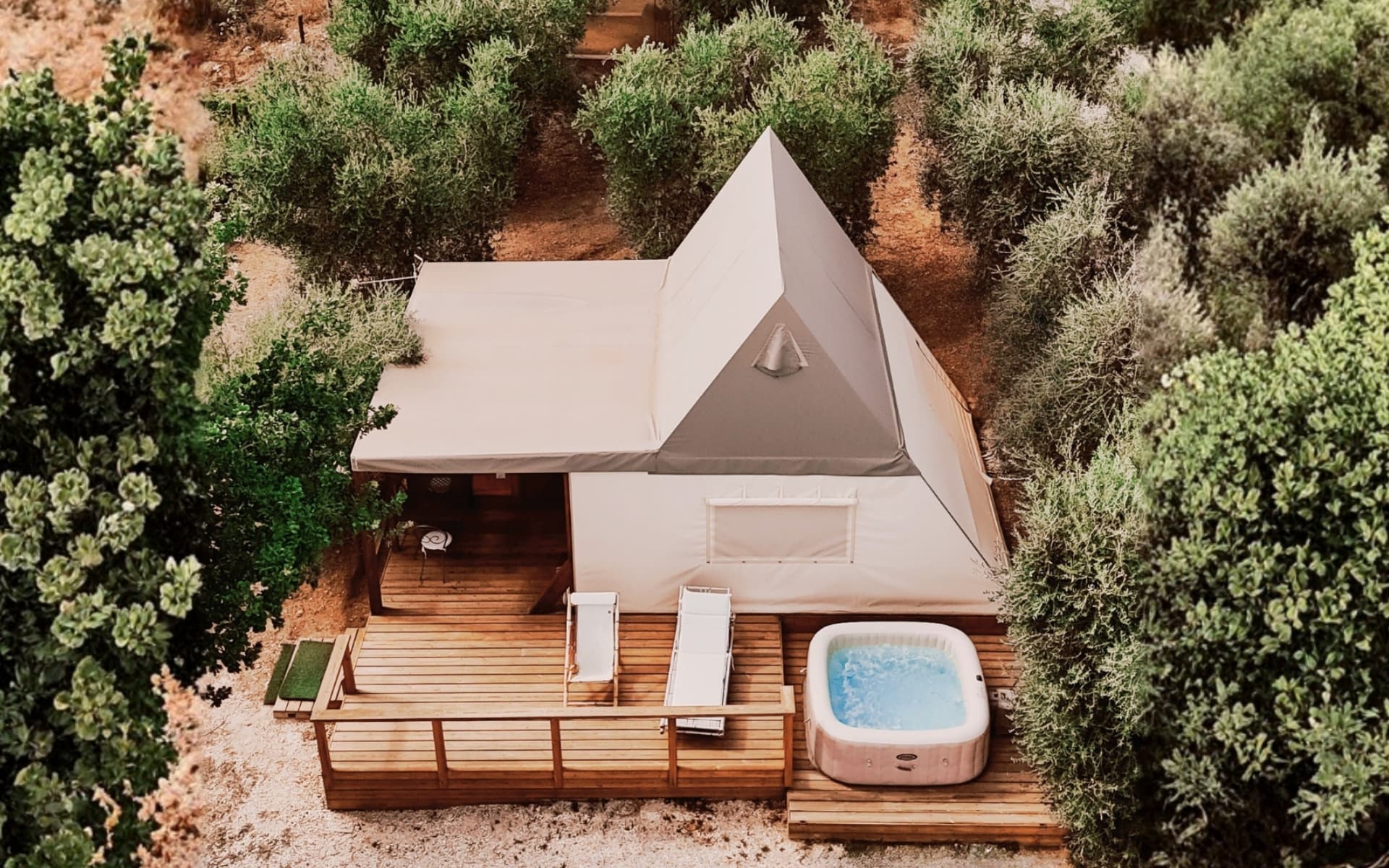 Luxury glamping tent with private jacuzzi hot tub on the veranda in Maremma, Saturnia.
