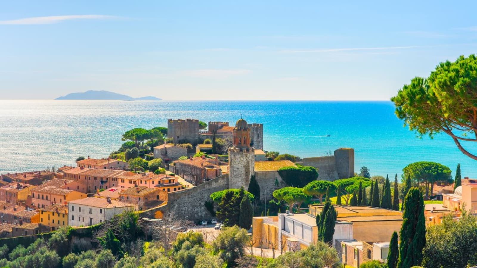 Aerial view of the medieval village of Castiglione della Pescaia with its walls and the turquoise sea