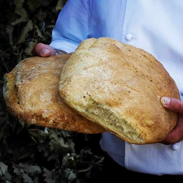 One person shows two loaves of potato bread