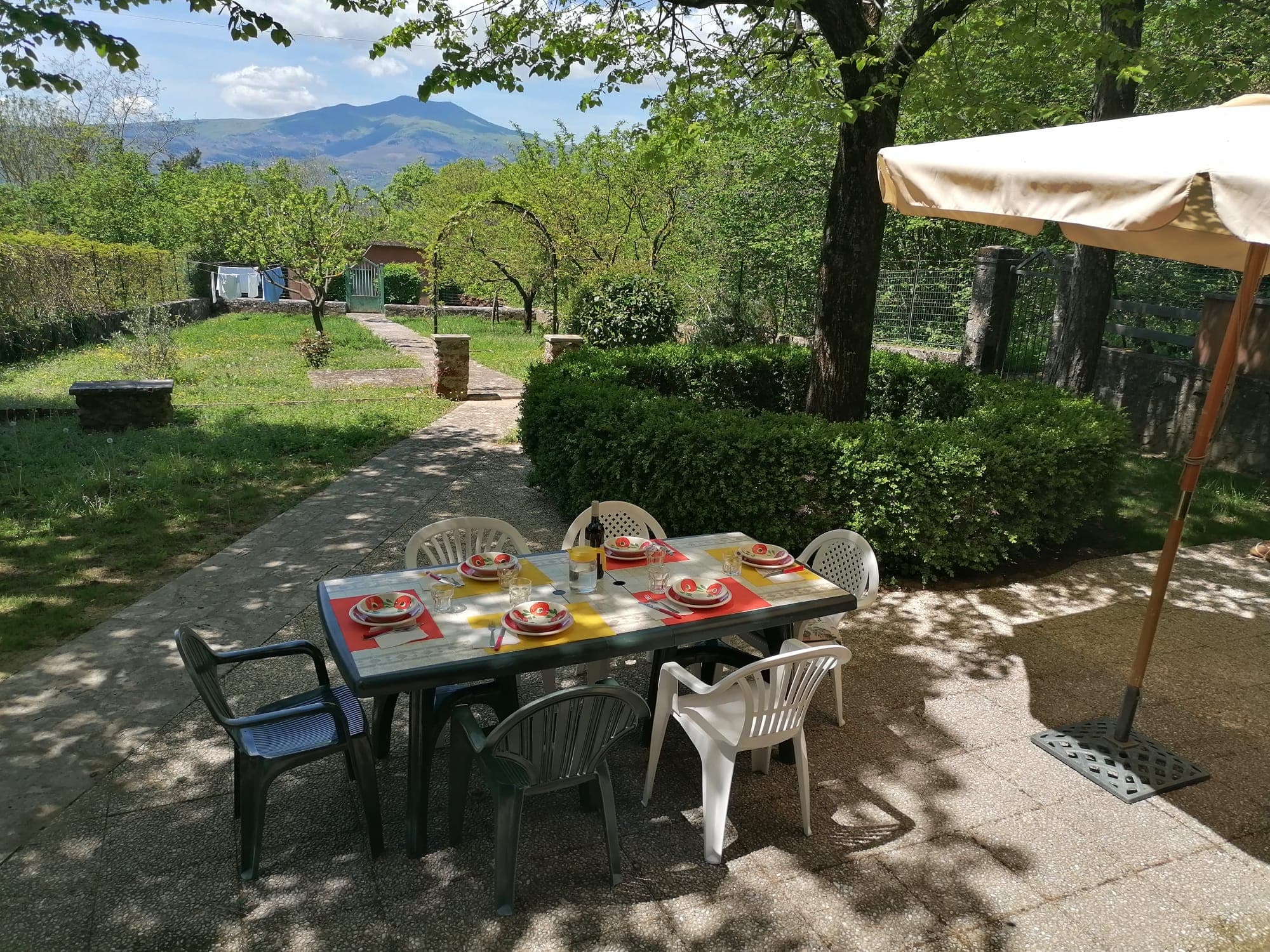 Table set in Villetta la Fortezza garden with Monte Amiata view