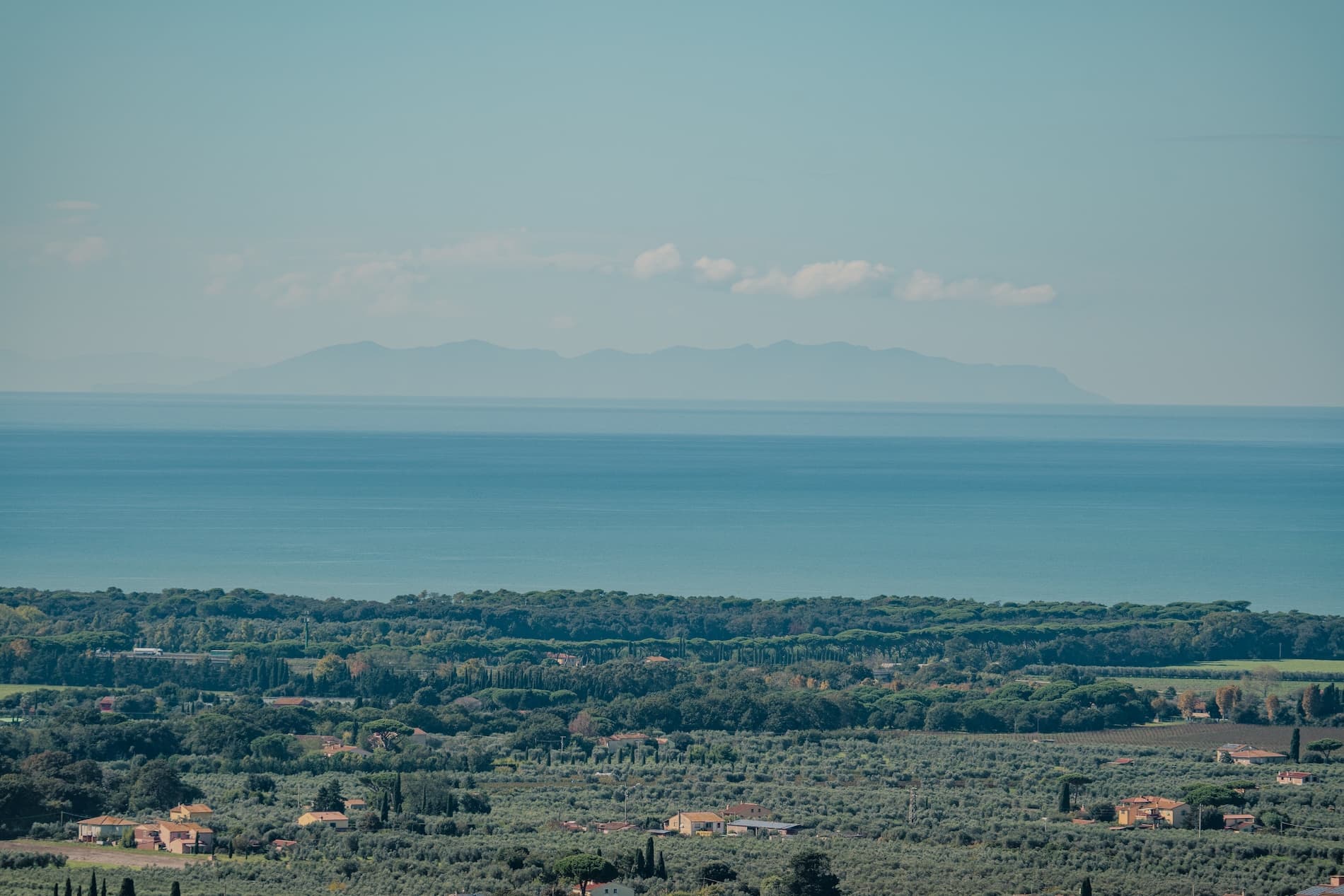 Panoramic view of Marina di Castagneto with farmland and the sea on the horizon