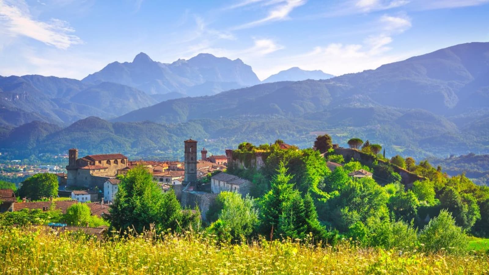Medieval village perched on a hill with the Apuan Alps in the background, Garfagnana