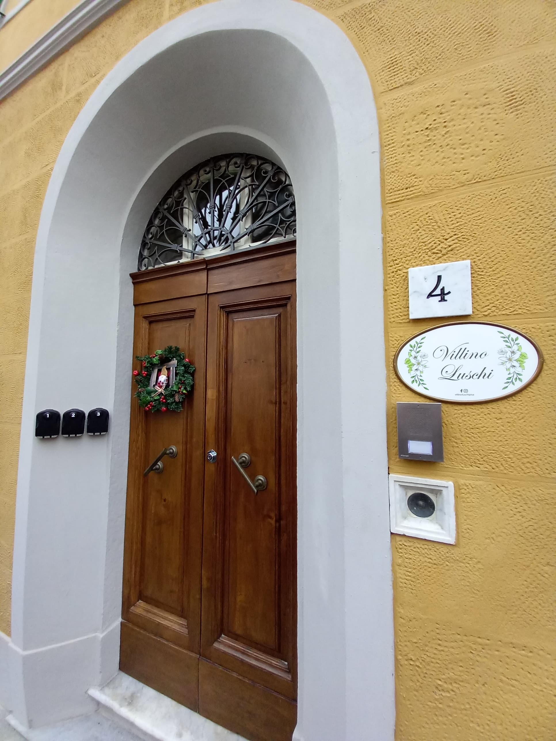Historic front door and sign of the Villino Luschi B&B, a residence dating from the early 20th century