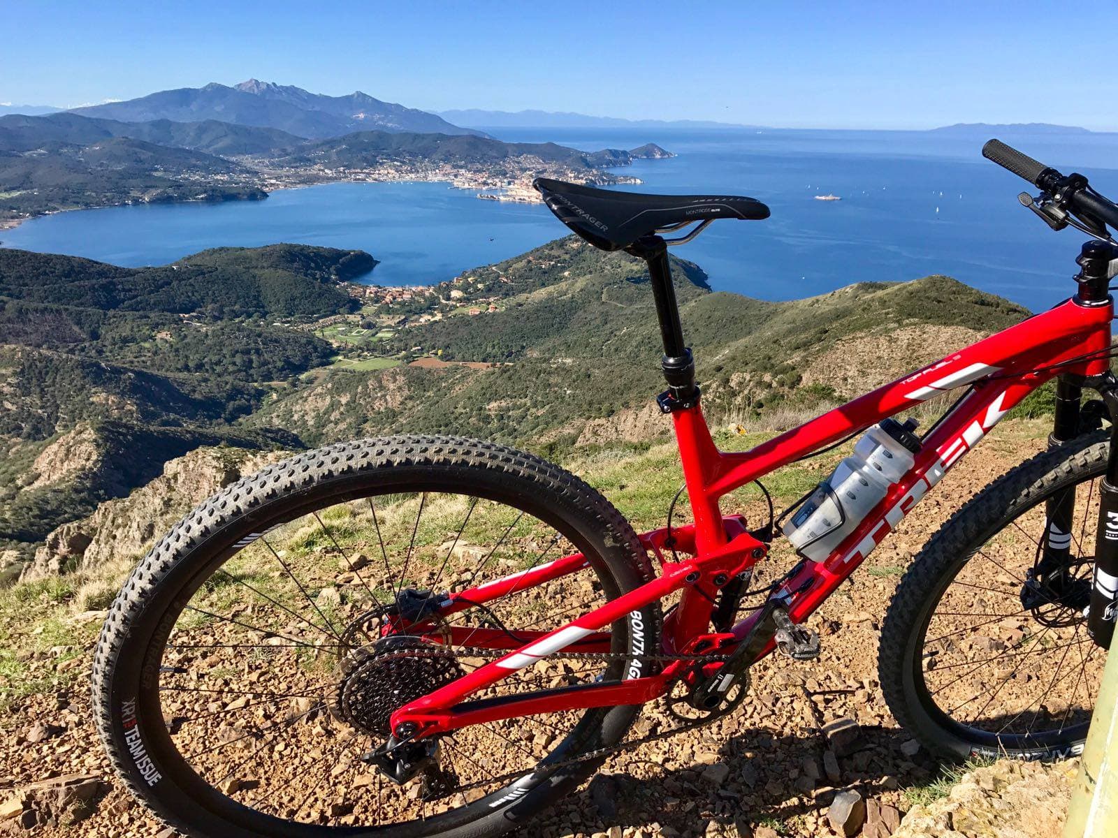 Una bici in primo piano, sullo sfondo l'Isola d'Elba